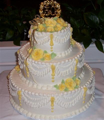 It was topped with a 50th emblem and a small gold bow Cake 